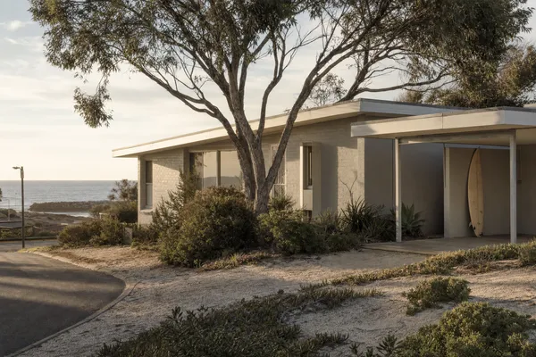 Original 1970s beach shack in driftwood grey near the rocky beach at Quinns Rocks