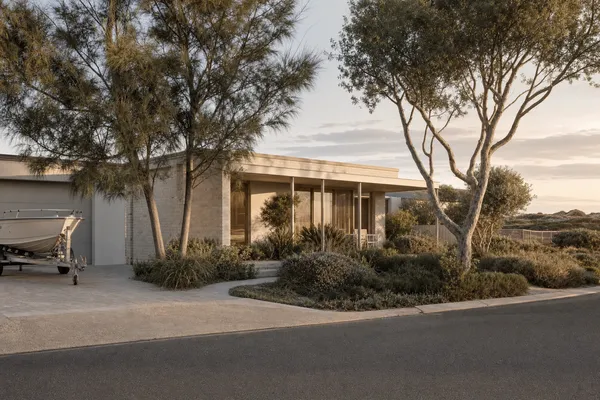 Relaxed single-storey home under casuarinas near the beach at Singleton, boat on the driveway